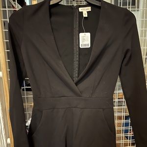 Woman black shorts romper, low v neck, size Small
